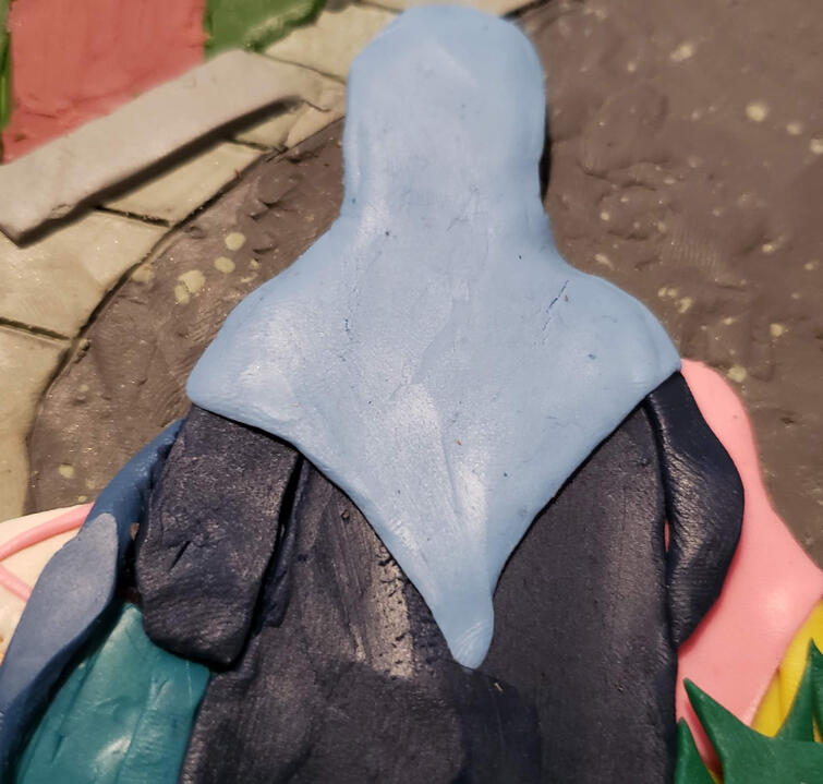 Plasticine illustration of Sakina Binterik walking through the city with her daughters