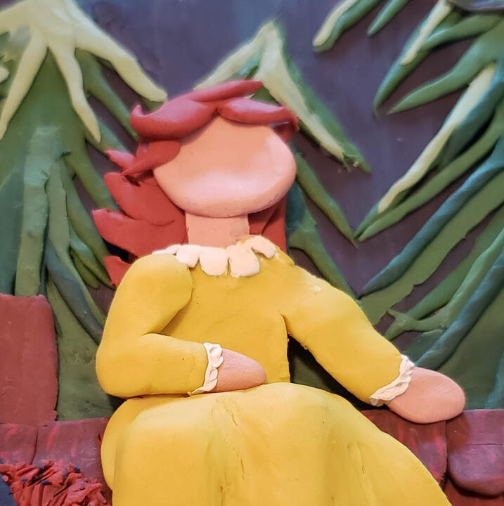 Plasticine illustration of a princess in a yellow dress on a roof with trees in the background